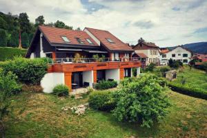 a house on top of a hill with a house at Les Epinettes Studio Prairie in Gérardmer