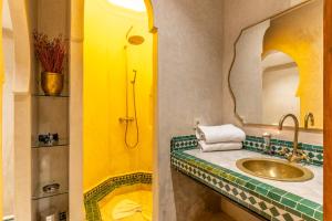 a bathroom with a sink and a mirror at Riad Habouba in Marrakesh +57 photos
