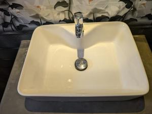 a sink with a faucet in a bathroom at The Aurora in Ahangama