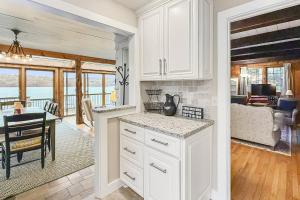 a kitchen with white cabinets and a dining room at Candlewood Isle in New Fairfield