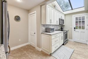 a kitchen with white cabinets and a skylight at Candlewood Isle in New Fairfield