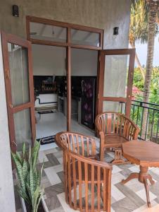 a patio with a table and two chairs and a table at The Aurora in Ahangama