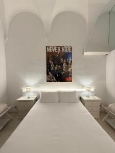 a bedroom with a bed with a poster on the wall at DUOMO26 BOUTIQUE APARTMENT in Desenzano del Garda
