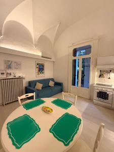 a living room with a table and a couch at DUOMO26 BOUTIQUE APARTMENT in Desenzano del Garda