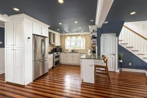 a kitchen with white cabinets and stainless steel appliances at Pine Creek Beach House in Fairfield