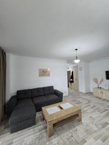 a living room with a couch and a coffee table at La Andrei in Bistriţa