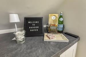 a welcome to harpoon brewery sign and a bottle of wine at Harbor Haven, Apt #4 - 2BR/1BA in Stamford