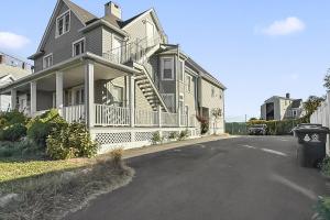 a large house with a porch and a driveway at Harbor Haven, Apt #4 - 2BR/1BA in Stamford