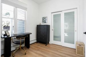 a office with a black desk and a cabinet at Harbor Haven, Apt #5, 3BR/2BA in Stamford +18 photos