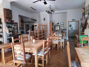 a dining room with wooden tables and chairs at Literaturhaus Schmökermühle in Andernach +39 photos