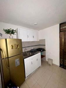 a kitchen with a refrigerator and a sink at Casa del Prado in Santa Marta