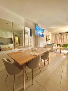 a dining room with a wooden table and chairs at Casa del Prado in Santa Marta