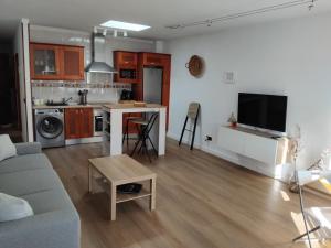 a living room with a couch and a kitchen at Casa Valentina in Tías