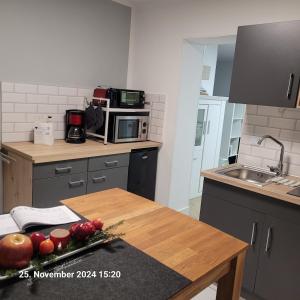 a kitchen with a table with fruit on it at Gemütliches Feriendomizil in Niederorschel +7 photos