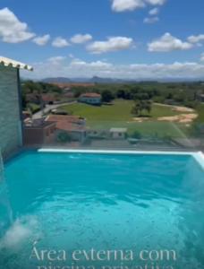 a swimming pool in a villa with a view at Casa de temporada em Jacaraípe in Serra