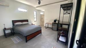 a bedroom with a bed and a mirror at Casa Kimara in Uvita