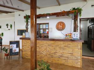 a bar in a restaurant with a wooden wall at DK2 Resort - Remote Beach Hideaway - Fast WiFi - Private Tours by Arrangement - Plan Ahead in El Nido