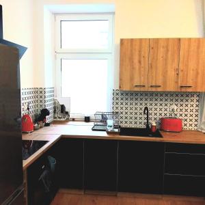 a kitchen with a sink and a window at Klonowicza One in Leszno