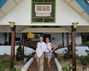 a man and a woman standing in front of a building at DK2 Resort - Remote Beach Hideaway - Fast WiFi - Private Tours by Arrangement - Plan Ahead in El Nido