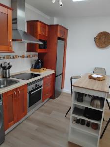 a kitchen with wooden cabinets and a stove top oven at Casa Valentina in Tías +12 photos