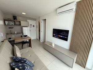 a living room with a couch and a table at Sunny Hall by AFT in Porto De Galinhas