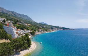 a view of a beach with buildings and the ocean at Apartment Krilo Jesenice 24 in Jesenice