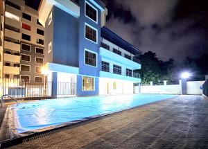 a swimming pool in front of a building at night at Shawmut Executive Suites With Heated Pool, GYM, Secure Parking, Full Power Backup in Nakuru