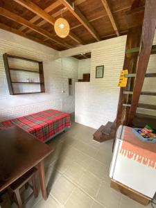 a room with a bed and a table in it at Pousada Vale da Praia in Praia do Rosa +66 photos