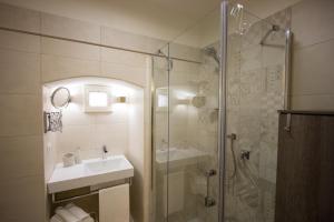 a bathroom with a shower and a sink and a tub at Ai Sottani B&B Deluxe Suite in Gioia del Colle +53 photos