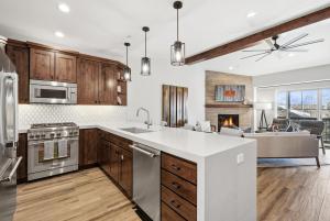 a kitchen with wooden cabinets and a fireplace at Snowline at Black Rock Ridge in Kamas