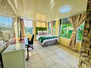 a bedroom with a bed and a desk and window at Honeyhills Excellence Resort E in Roodepoort