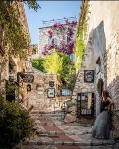 a bride and groom standing outside of a building at STUDIO pied village EZE - dans VILLA - Parking Gratuit in Éze
