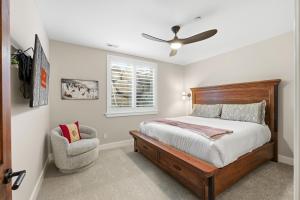a bedroom with a bed with a ceiling fan and a chair at Snowline at Black Rock Ridge in Kamas