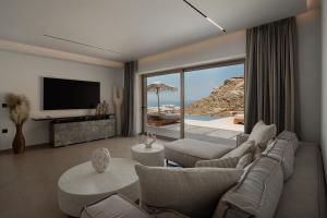a living room with a view of the ocean at GkF Luxury Villas in Naxos Chora