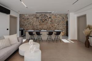 a kitchen and living room with a couch and a table at GkF Luxury Villas in Naxos Chora