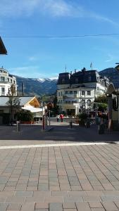 a town square with buildings in the background at Pension Buchner in Zell am See
