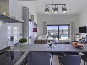 a kitchen and living room with a table and chairs at GuestReady - Luxury Villa with Pool in Antigua