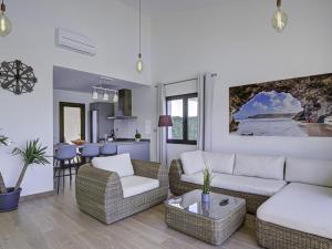 a living room with two couches and a kitchen at GuestReady - Luxury Villa with Pool in Antigua