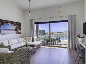 a living room with a couch and a table at GuestReady - Luxury Villa with Pool in Antigua