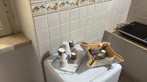 a bathroom with a toilet with a basket on the tank at Casa di Mario in Graffignano +10 photos