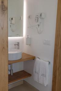 a bathroom with a sink and a mirror and towels at Casa Refúgio da Natureza in Macedo de Cavaleiros +15 photos