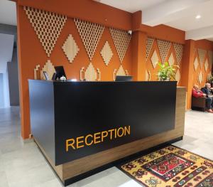 a reception area in a lobby with a reception desk at MIK Hotel Korça in Korçë