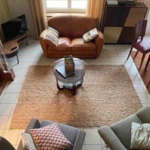 a living room with a couch and a coffee table at Ty Breiz in Plouézec