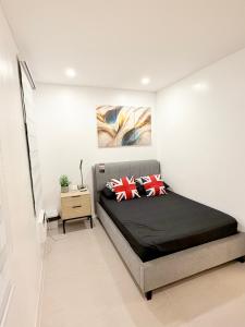 a bedroom with a bed with two pillows on it at Kaizen Urban Retreat - Elevate Your Stay in Calo +18 photos