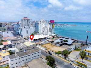 an aerial view of a city with buildings and the ocean at Hotel Marvento Suites in Salinas