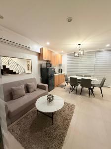 a living room with a couch and a table at Kaizen Urban Retreat - Elevate Your Stay in Calo