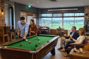 a group of people playing pool in a restaurant at The Dark Hedges Hotel in Stranocum