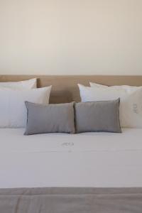 a bed with white pillows on top of it at Casa Veigas in Macedo de Cavaleiros +15 photos