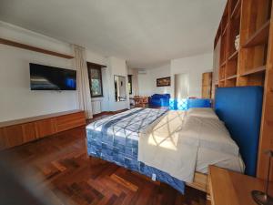 a bedroom with a bed with a blue comforter at Blue emotion, into wellness & wilderness in Albano Laziale