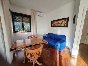 a living room with a table and a blue couch at Blue emotion, into wellness & wilderness in Albano Laziale